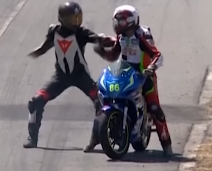 Motorcycle racer hitches a ride on his opponent