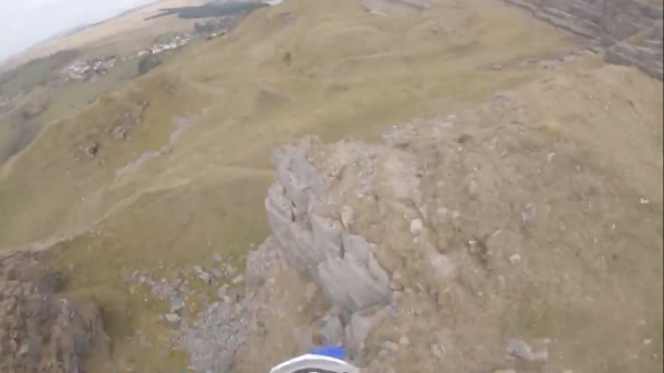 Rider crashes off cliff face