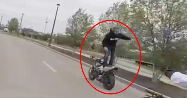 Riding a motorcycle standing up whilst facing backwards