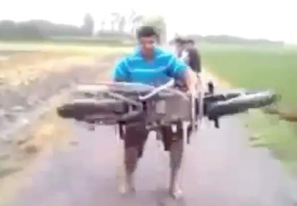 WATCH: Man lifts motorcycle above his head