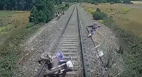 Video: Rider jumps for his life as train hits his dirt bike