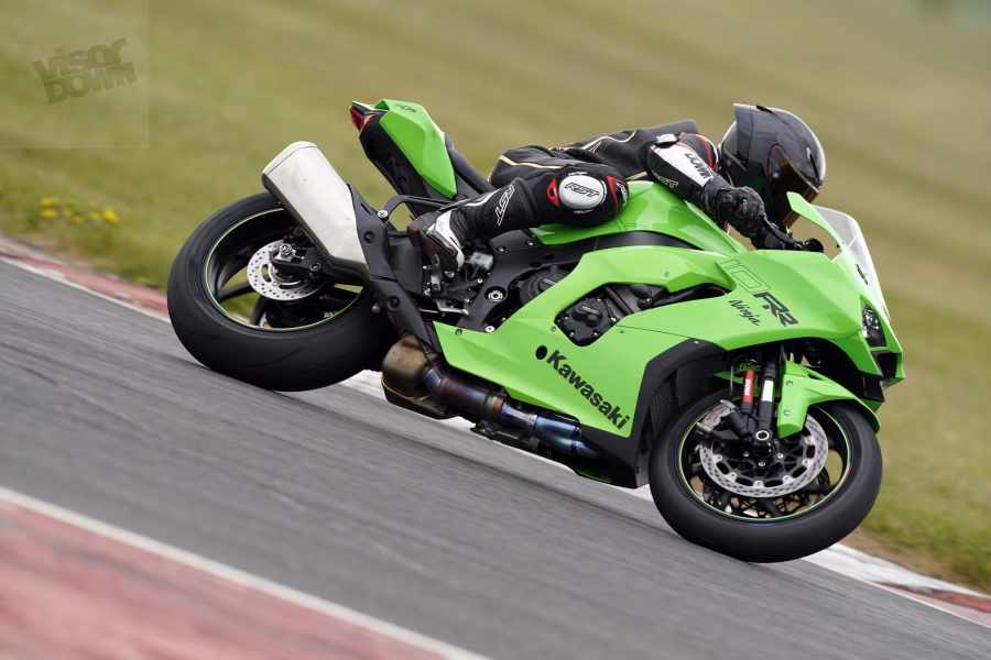 A green and black 2021 Kawasaki Ninja ZX-10R being ridden on a track
