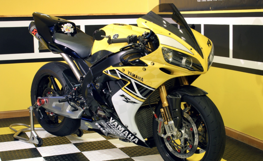 A yellow 2006 Yamaha R1 SP standing on a tiled floor