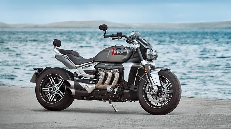 A silver and black 2020 Triumph Rocket 3R standing in front of a body of water