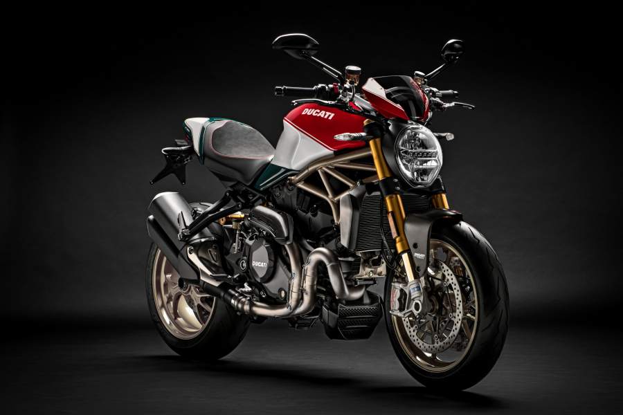 A red, white and gold Ducati Monster 1200 in a studio