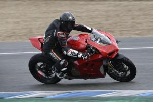 A red 2022 Ducati Panigale V4S being ridden around a racetrack