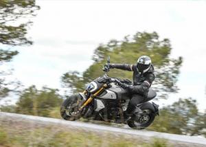A black, white and gold 2019 Ducati Diavel 1260S being ridden on a country road
