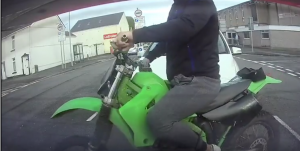 Unskilled motorcyclist comically fails wheelie attempt on British road