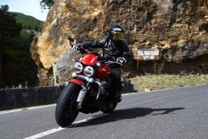 A red 2020 Triumph Rocket 3 being ridden on a road